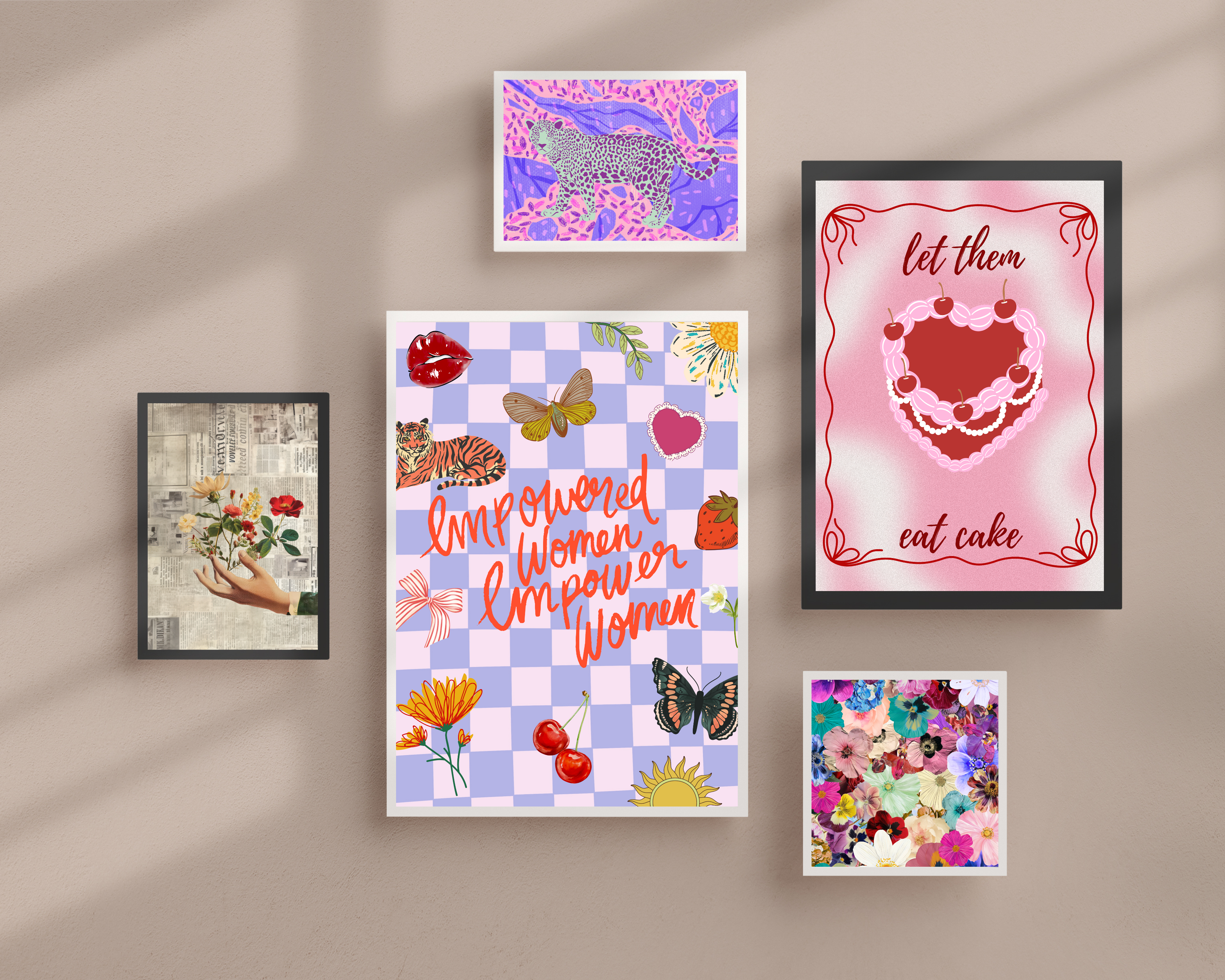 Gallery wall with five colorful framed art prints on a beige wall: vintage hand with flowers, purple leopard, floral collage, heart cake with ‘let them eat cake,’ and large checkered print with butterflies, cherries and ‘Empowered Women Empower Women’ quote.