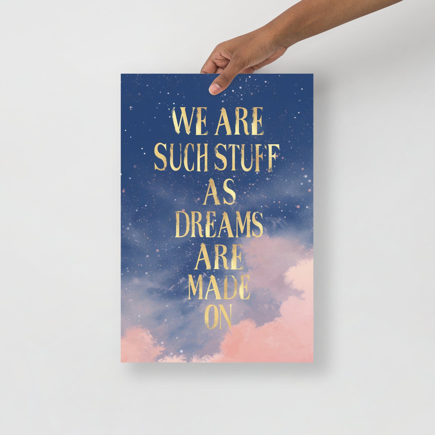 Unframed wall art matte print with gold text reading “We are such stuff as dreams are made on” over a dreamy starry night sky with pink clouds"